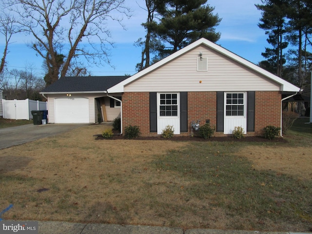 ranch-style house featuring a garage and a front yard