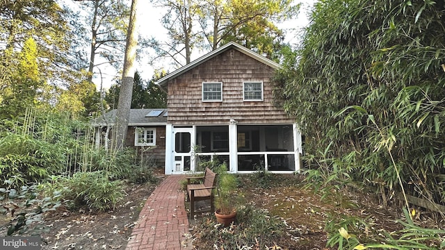 rear view of property with a sunroom