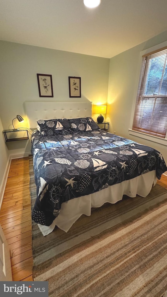 bedroom with hardwood / wood-style floors