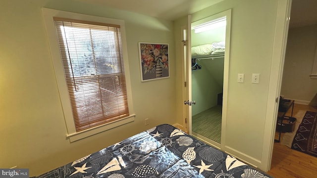 bedroom featuring hardwood / wood-style flooring and a closet