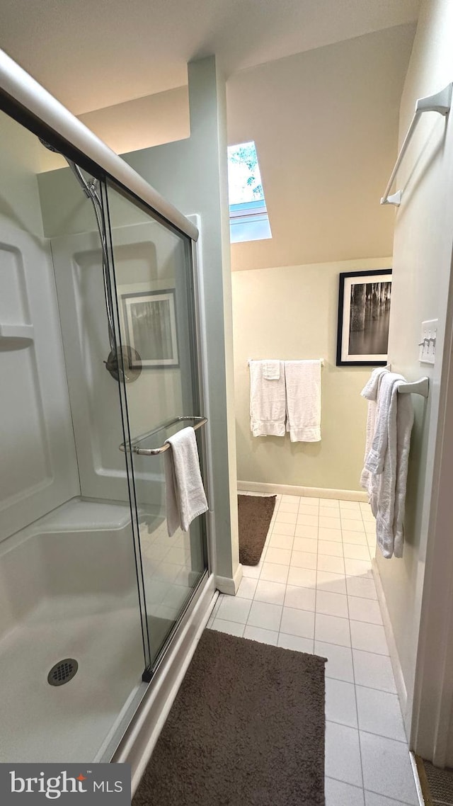 bathroom featuring tile patterned floors and a shower with door