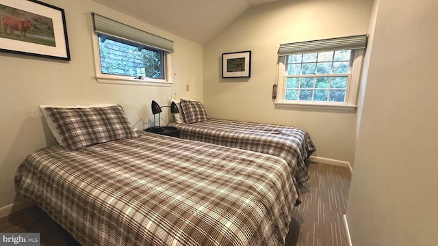 carpeted bedroom featuring lofted ceiling