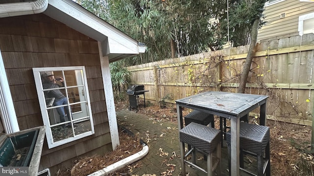 wooden terrace featuring grilling area