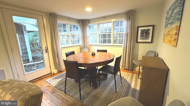 dining space with hardwood / wood-style floors