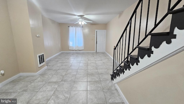 entryway with ceiling fan and light tile patterned floors