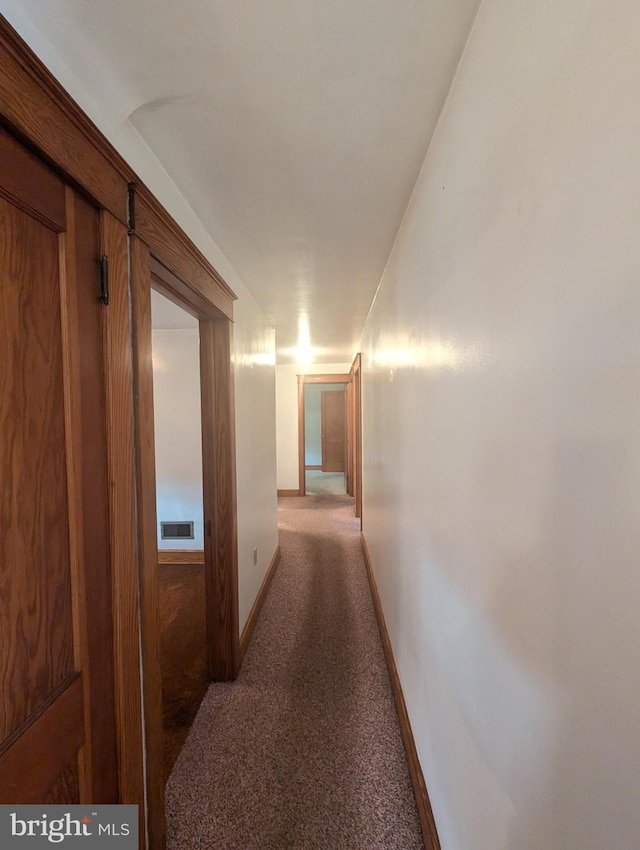 hallway with dark carpet