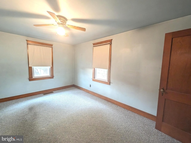 empty room featuring light carpet and ceiling fan