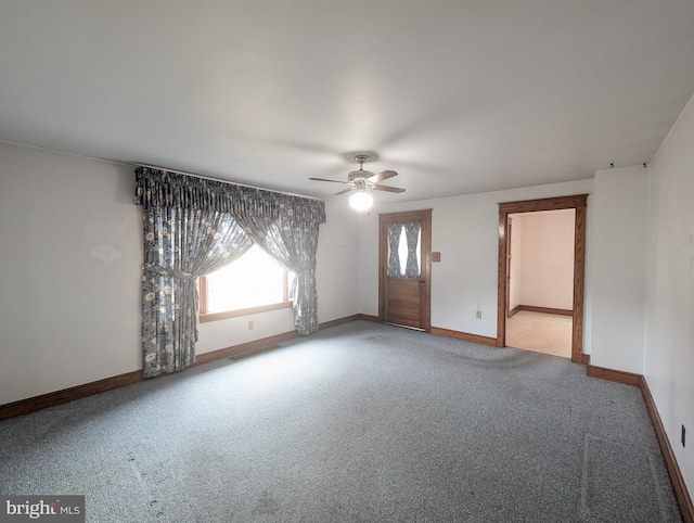 carpeted spare room with ceiling fan