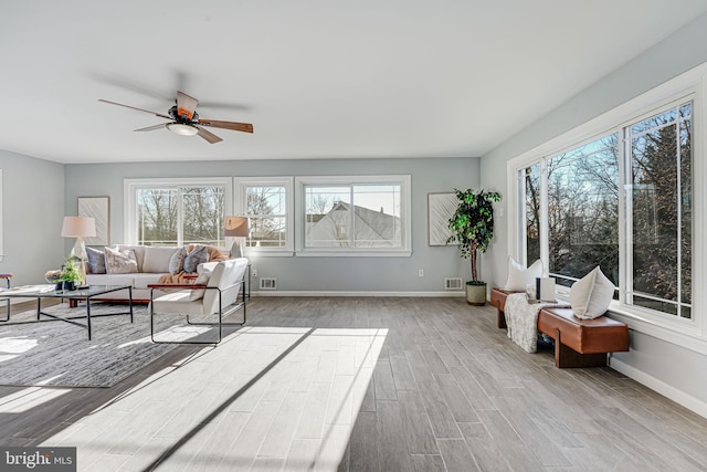 sunroom / solarium featuring ceiling fan