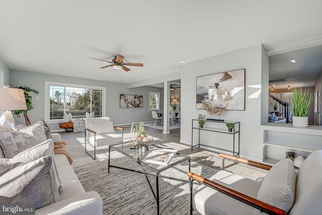 living room with ceiling fan and light hardwood / wood-style flooring