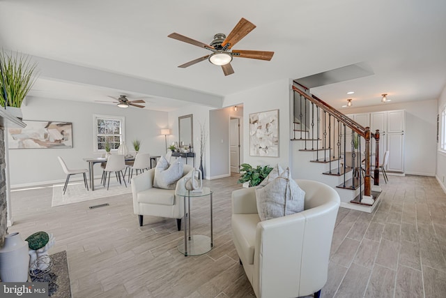 living room with ceiling fan and light hardwood / wood-style flooring