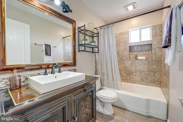 full bathroom with vanity, shower / bathtub combination with curtain, and toilet