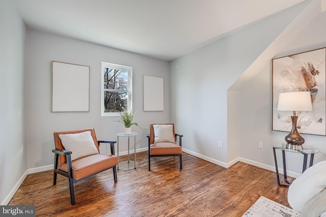 sitting room with hardwood / wood-style flooring