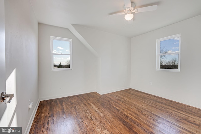 additional living space featuring ceiling fan, dark hardwood / wood-style flooring, and vaulted ceiling