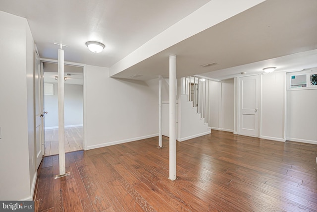 basement with dark hardwood / wood-style floors