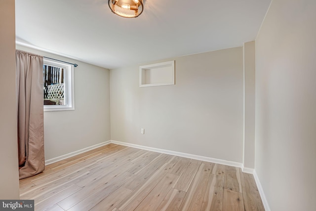 spare room with light hardwood / wood-style floors