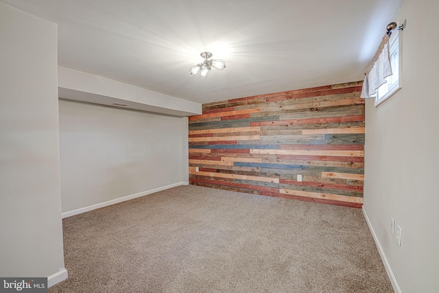 basement featuring carpet and wooden walls