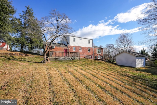 view of yard with a wooden deck and a shed