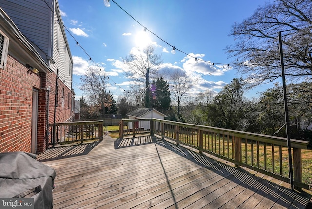 wooden terrace featuring a grill