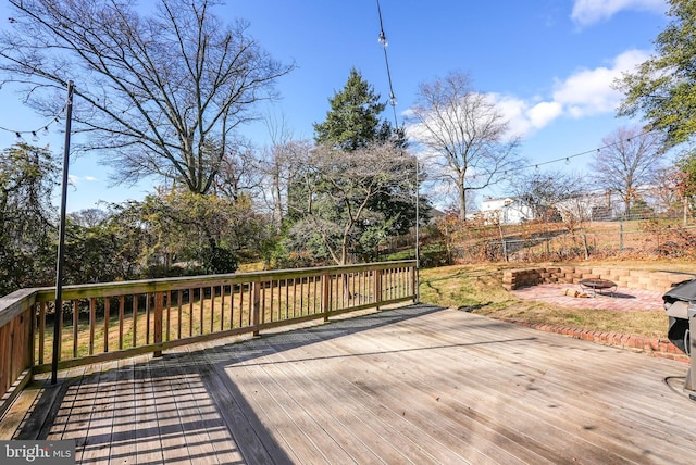 wooden deck featuring an outdoor fire pit