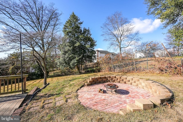 view of yard featuring an outdoor fire pit and a wooden deck