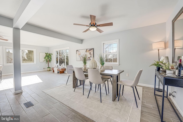 dining space featuring ceiling fan, beam ceiling, and a wealth of natural light