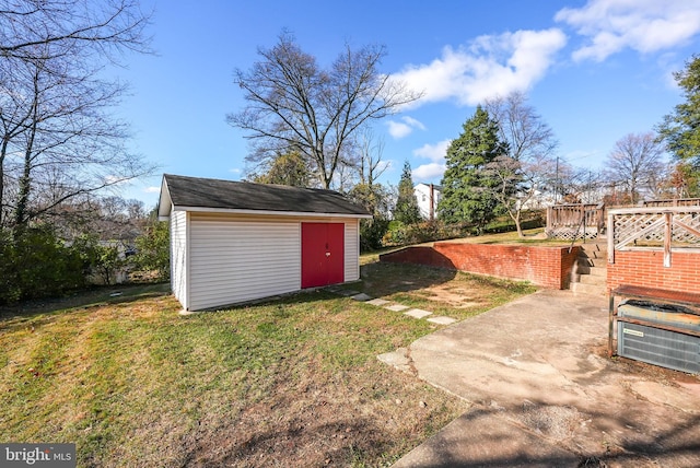 view of yard featuring a storage unit and a wooden deck