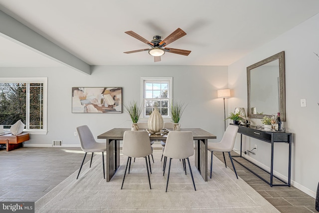 dining room featuring beamed ceiling and ceiling fan