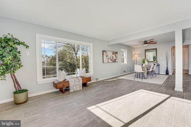 living area featuring ceiling fan and wood-type flooring