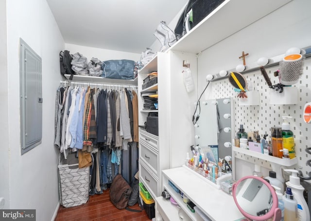 walk in closet with dark wood-type flooring and electric panel