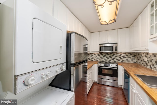 kitchen with butcher block countertops, white cabinetry, and stainless steel appliances