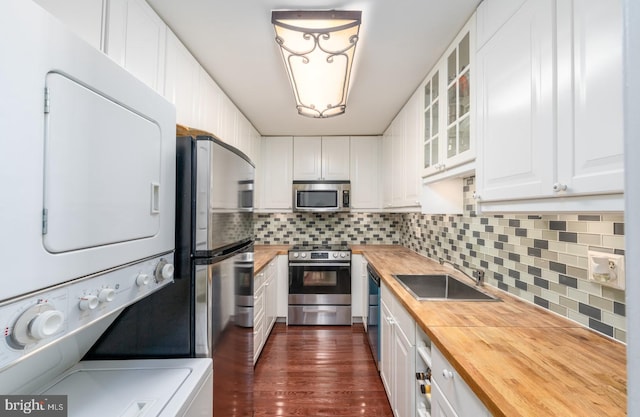 kitchen with white cabinetry, sink, stainless steel appliances, dark hardwood / wood-style floors, and butcher block countertops