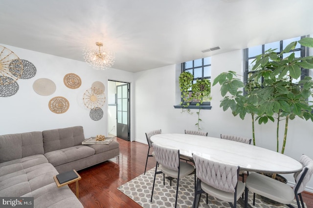 dining area with a chandelier, dark hardwood / wood-style flooring, and expansive windows