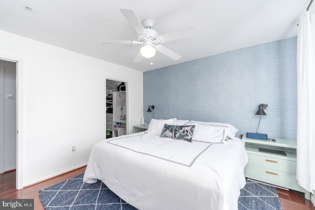 bedroom featuring ceiling fan and dark wood-type flooring