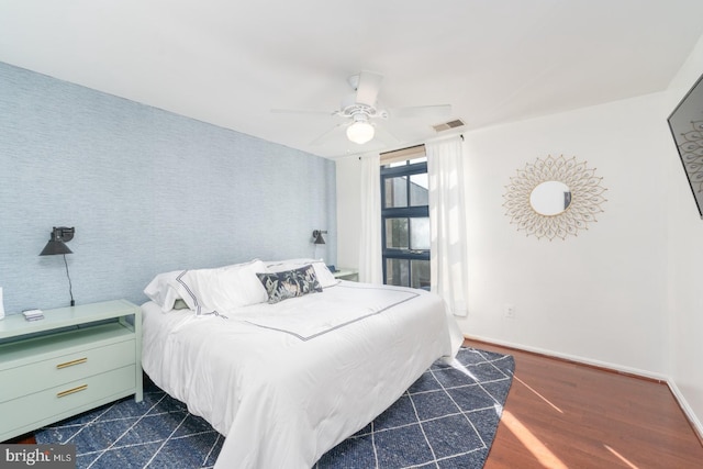 bedroom with ceiling fan and dark hardwood / wood-style floors