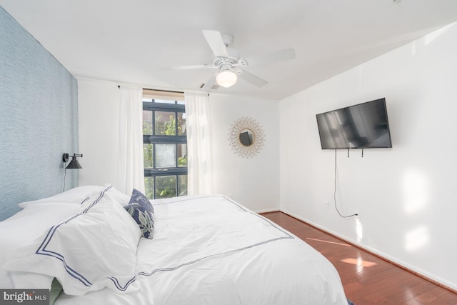 bedroom featuring ceiling fan and dark wood-type flooring