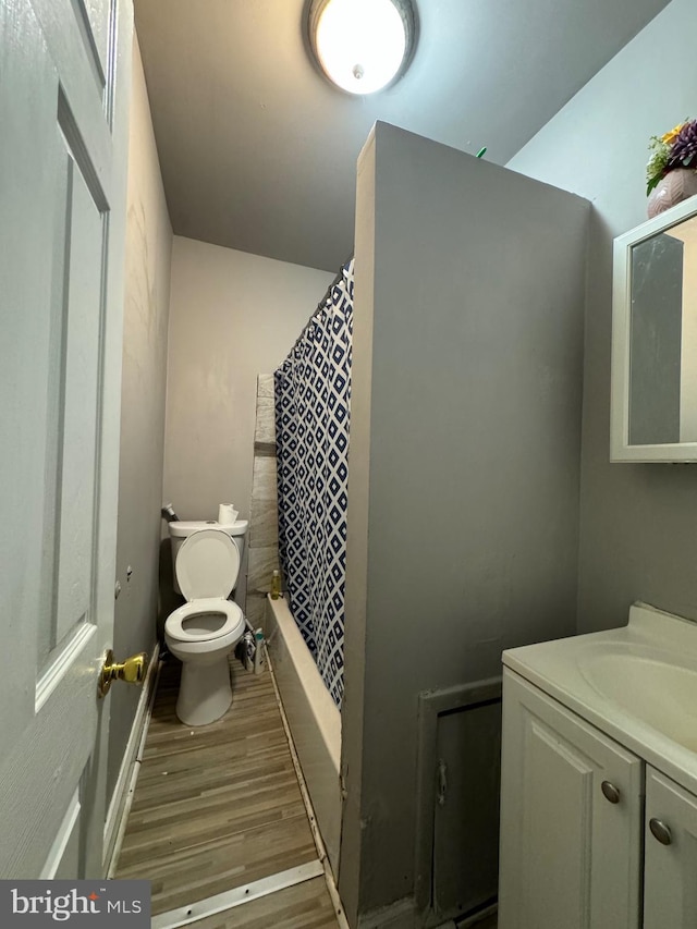 bathroom featuring a shower with shower curtain, vanity, wood-type flooring, and toilet