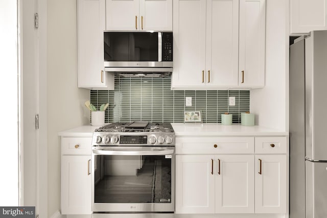 kitchen with white cabinetry, appliances with stainless steel finishes, and tasteful backsplash