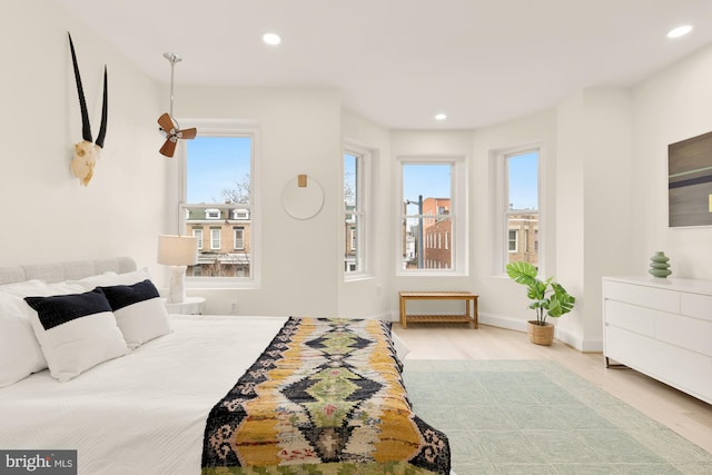 bedroom featuring light hardwood / wood-style flooring and multiple windows