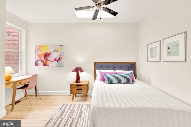 bedroom with wood-type flooring and ceiling fan