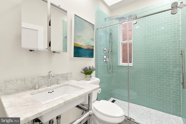 bathroom with toilet, an enclosed shower, and sink