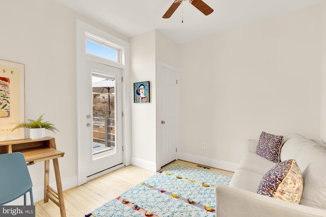 foyer with light wood-type flooring and ceiling fan