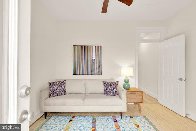 living room featuring hardwood / wood-style flooring and ceiling fan