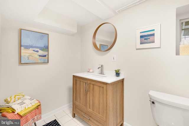 bathroom featuring tile patterned flooring, vanity, and toilet