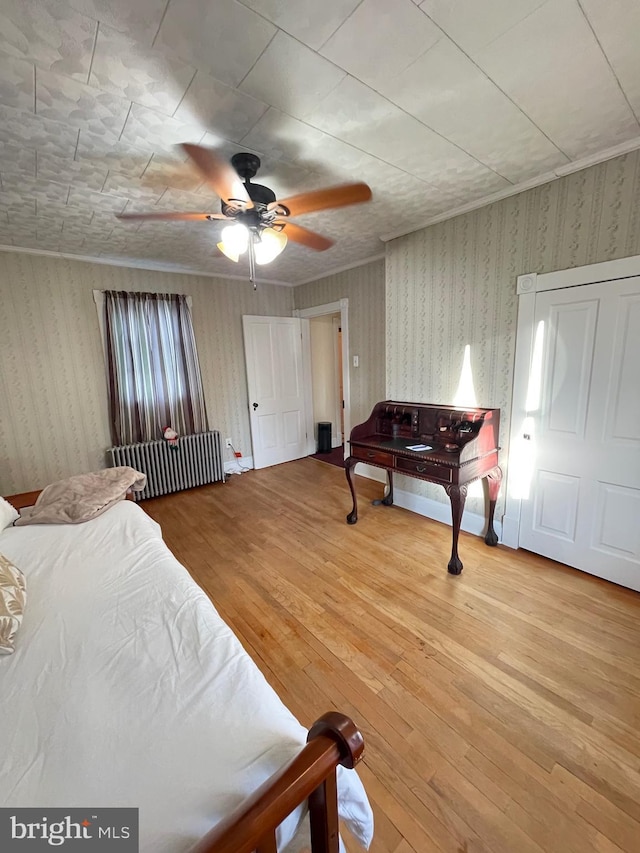 bedroom with wood-type flooring and ceiling fan