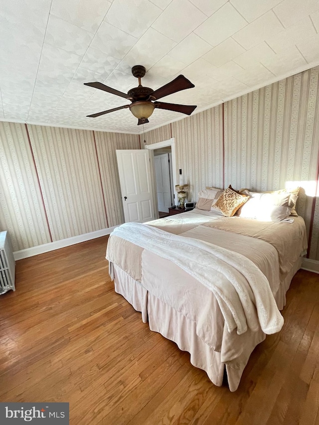 bedroom with ceiling fan and wood-type flooring