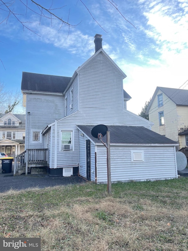 211 W 6th St, Laurel, DE 19956 - back of property with a chimney, a wooden deck, cooling unit, and a lawn