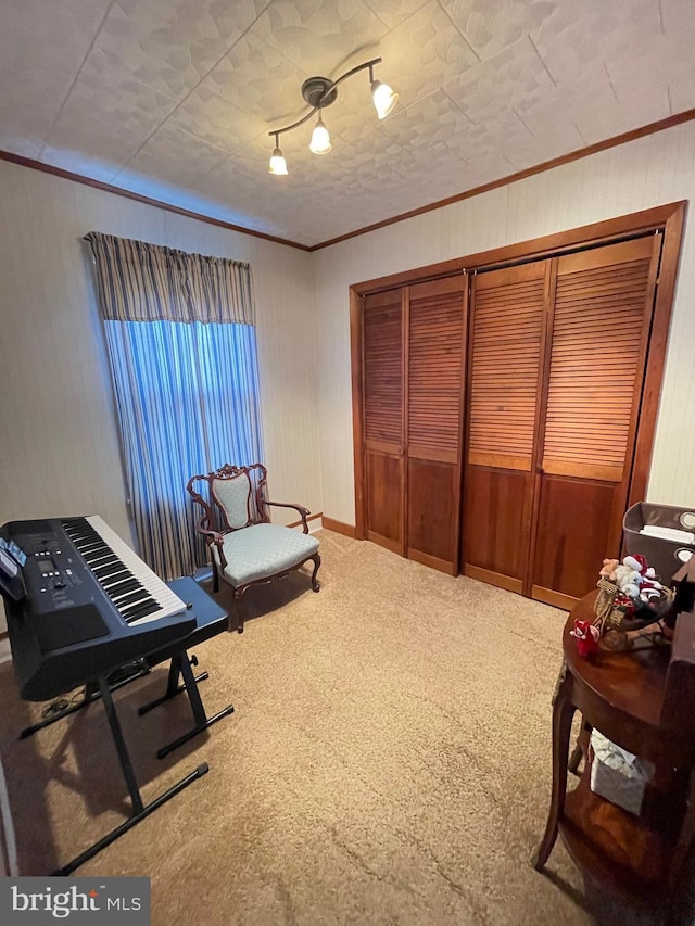 sitting room featuring carpet and ornamental molding