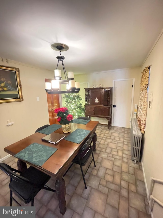 dining room with a chandelier and radiator