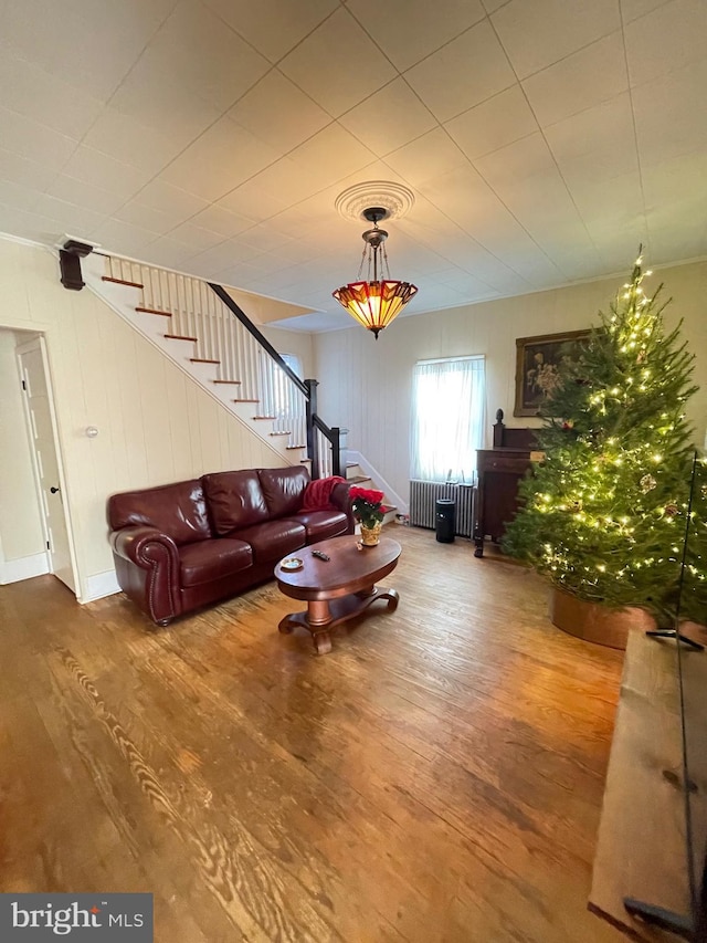 211 W 6th St, Laurel, DE 19956 - living area with radiator heating unit, stairs, and wood finished floors
